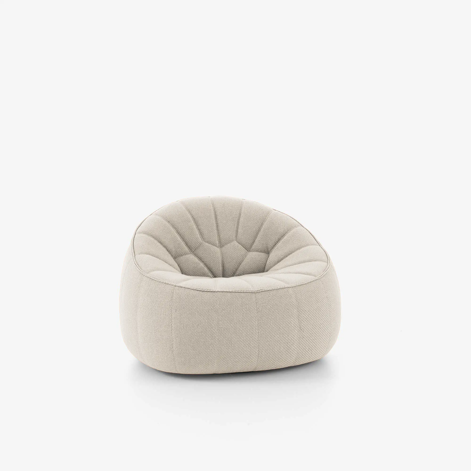 Modern off-white cushioned armchair with rounded shape and subtle stitched pattern on the backrest.