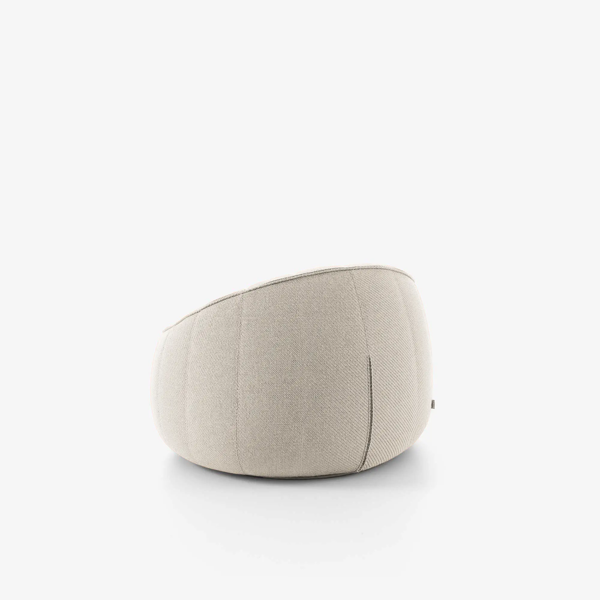 Back view of a beige fabric modern armchair with curved design on white background.