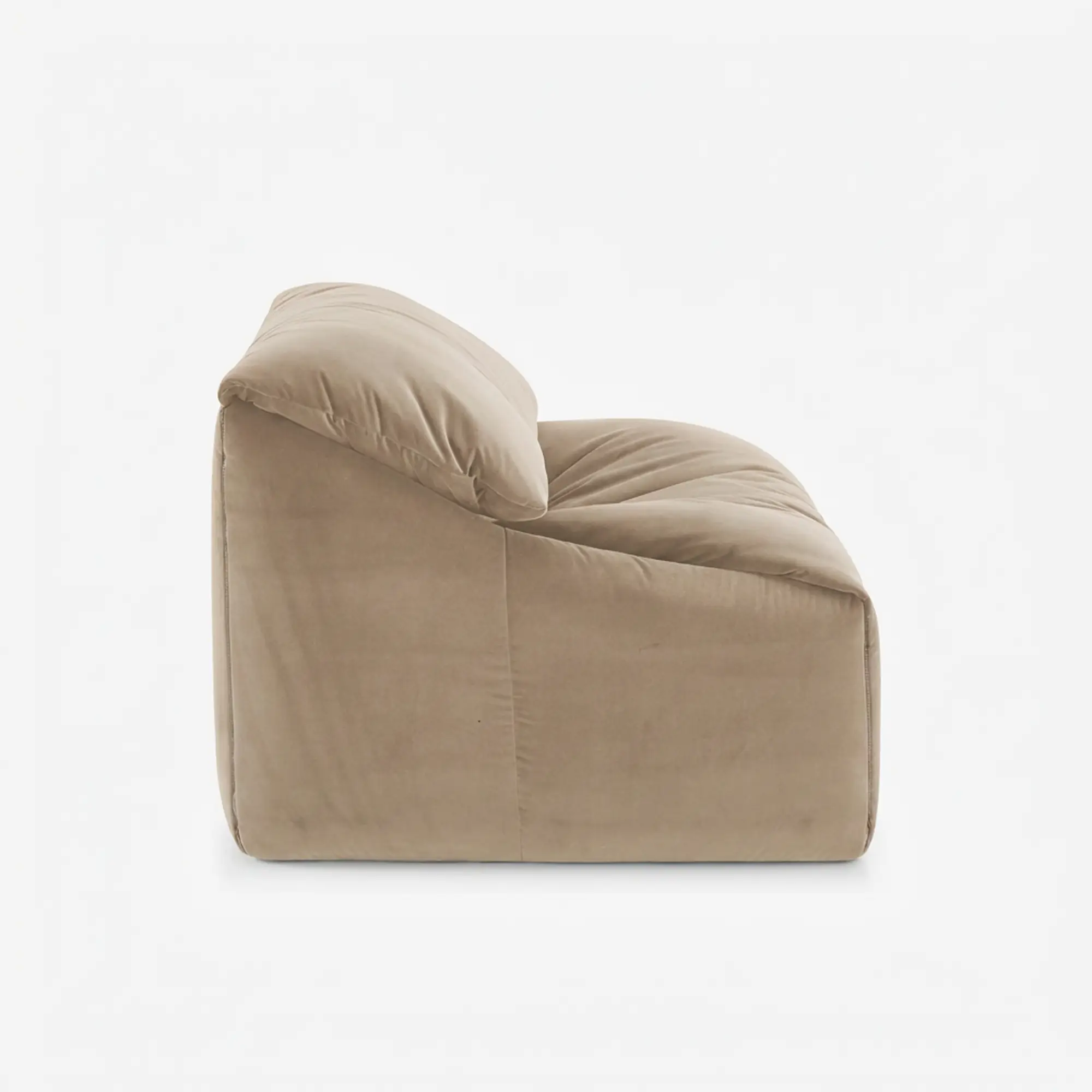 Side view of a beige plush armchair with a soft, cushioned back and seat.